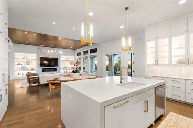 a kitchen with a stove and a wooden floor