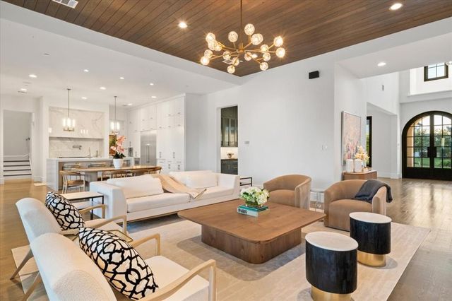 a living room with furniture and a chandelier