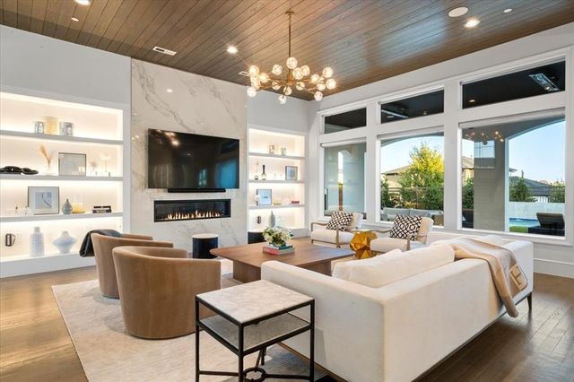 a living room with fireplace furniture and a flat screen tv