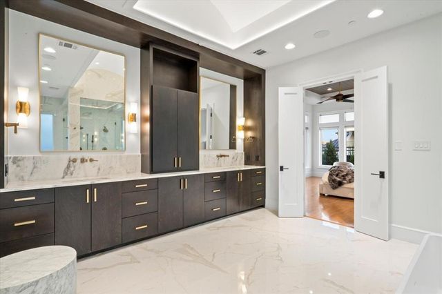 a spacious bathroom with a double vanity sink and a mirror