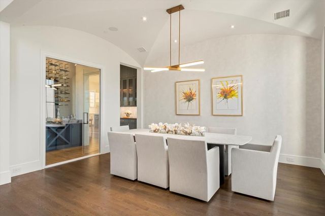 a view of a room with kitchen island stainless steel appliances wooden floor and windows