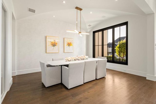 a living room with stainless steel appliances granite countertop furniture a fireplace and a large window