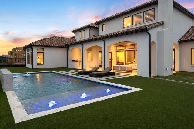 a view of a house with swimming pool and a yard