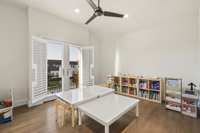 a living room with furniture a bookshelf and a wooden floor