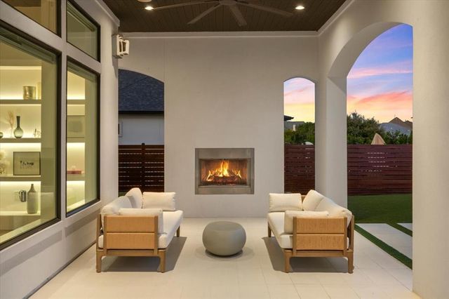 a living room with furniture and a floor to ceiling window
