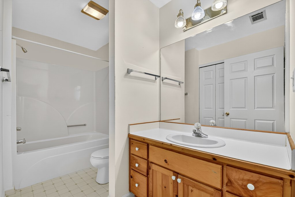 12 Sunset Court Blue Ridge, GA 30513 - Photo 11 of 23 a bathroom with a sink a toilet a mirror a bathtub and shower