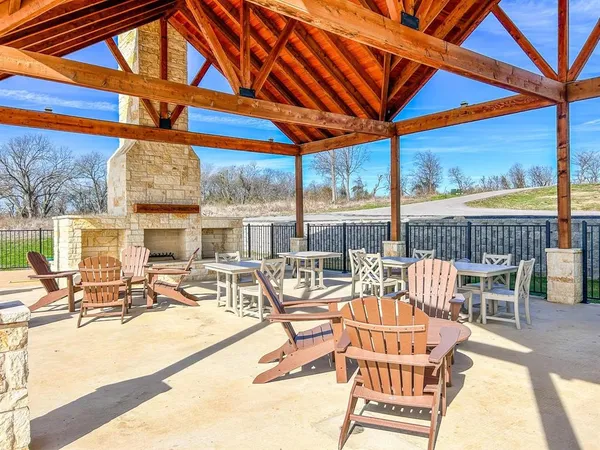 a view of a patio with a table chairs and wooden floor