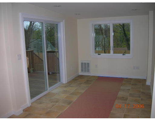 116 Roundwood Road Newton, MA 02464 - Photo 6 of 16 a view of an empty room with a window