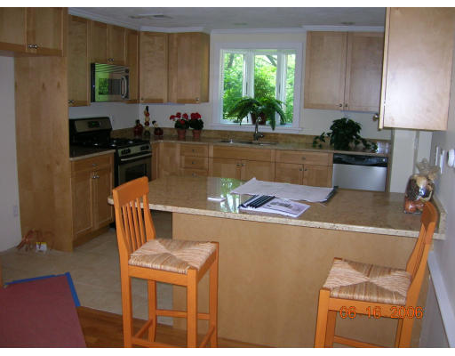 116 Roundwood Road Newton, MA 02464 - Photo 9 of 16 a kitchen with a sink a stove and a refrigerator