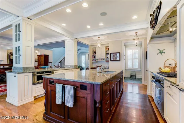 a living room with furniture a flat screen tv and a table