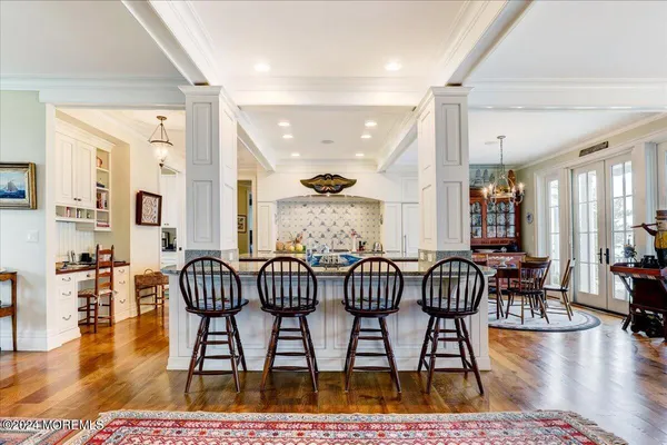 a living room with furniture and painting on the wall