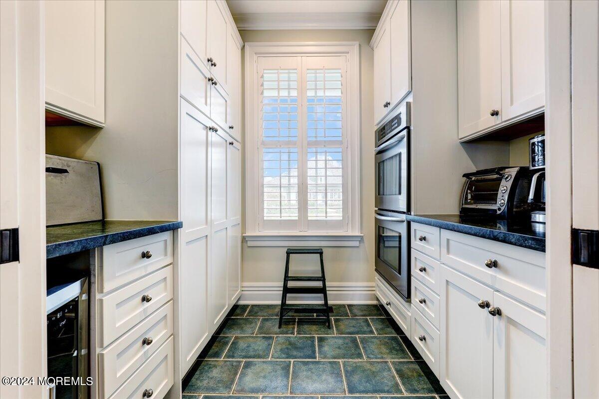 225 Channel Lane Mantoloking, NJ 08738 - Photo 15 of 85 a kitchen with white cabinets and appliances