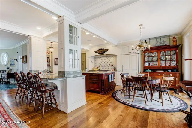 a view of a hallway with wooden floor and furniture