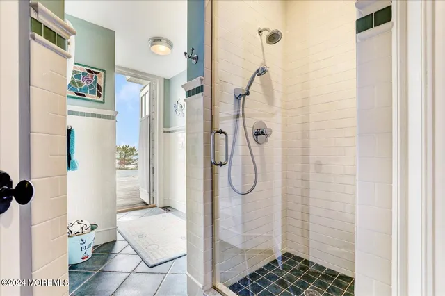 a living room with furniture kitchen view and a wooden floor