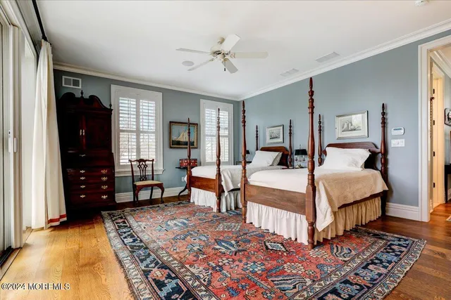 a bedroom with a large bed and a chandelier