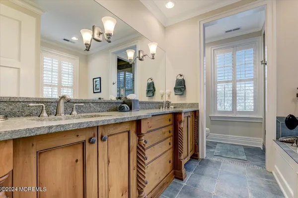 a bathroom with a toilet sink and mirror