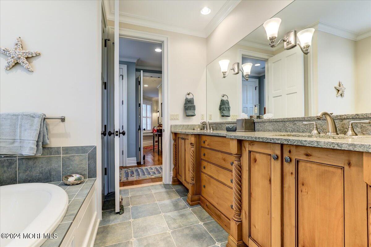 225 Channel Lane Mantoloking, NJ 08738 - Photo 35 of 85 a bathroom with a granite countertop sink mirror and bathtub