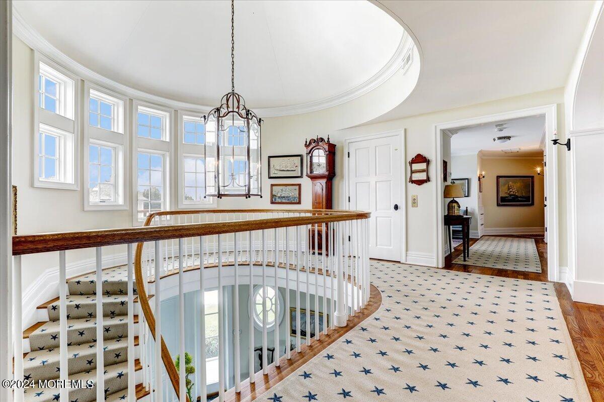 225 Channel Lane Mantoloking, NJ 08738 - Photo 37 of 85 a view of a hallway with wooden floor and windows