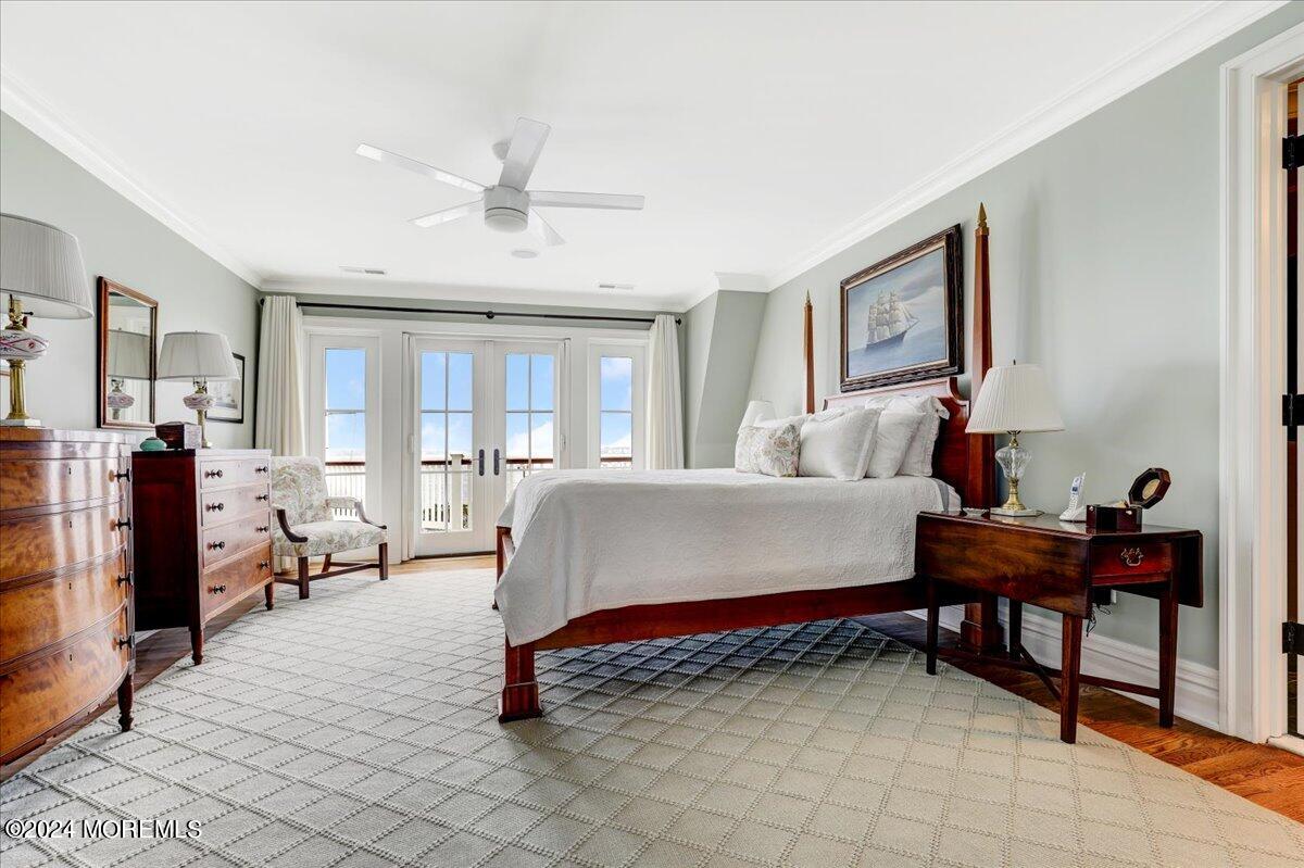 225 Channel Lane Mantoloking, NJ 08738 - Photo 43 of 85 a bedroom with a bed and a chandelier