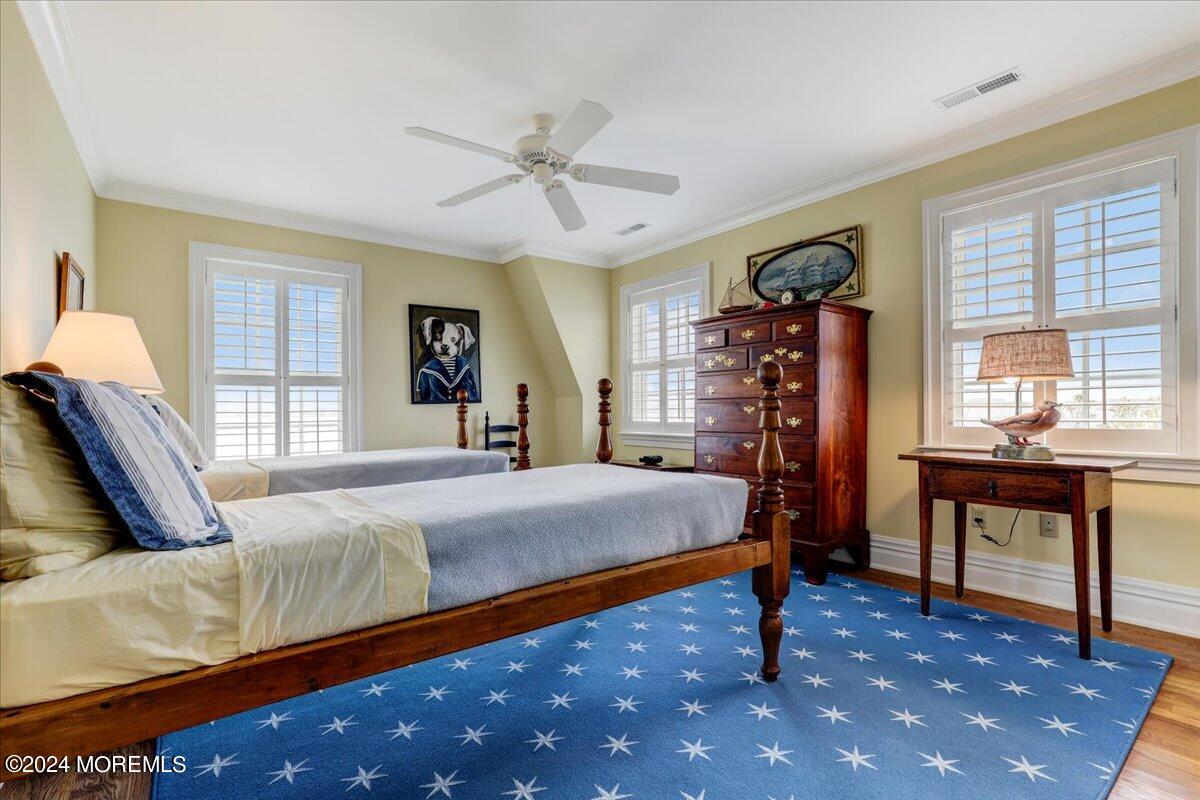 225 Channel Lane Mantoloking, NJ 08738 - Photo 48 of 85 a bedroom with a large bed and a chandelier