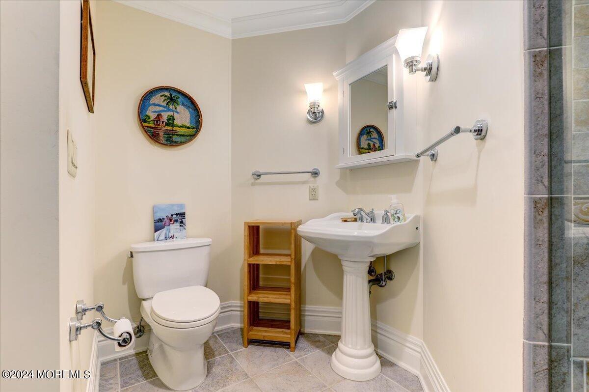 225 Channel Lane Mantoloking, NJ 08738 - Photo 54 of 85 a bathroom with a toilet sink and mirror