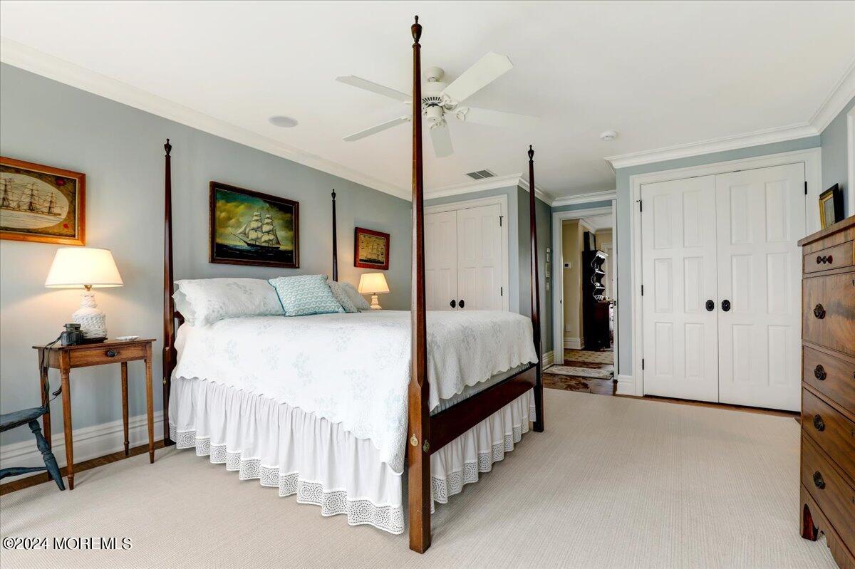 225 Channel Lane Mantoloking, NJ 08738 - Photo 57 of 85 a spacious bedroom with a bed a lamp and a flat screen tv