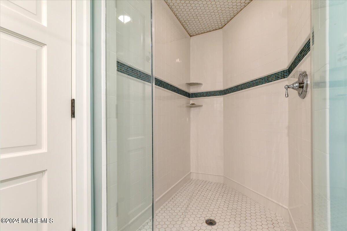 225 Channel Lane Mantoloking, NJ 08738 - Photo 59 of 85 a bathroom with a shower and a glass door