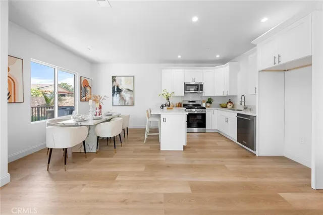 a kitchen with cabinets appliances a sink and a counter top space