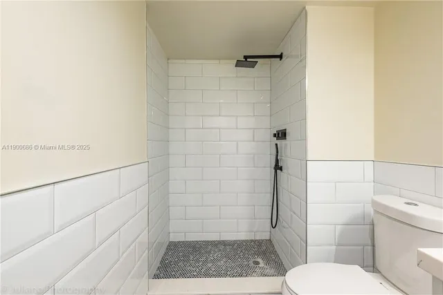 a bathroom with a toilet and a shower
