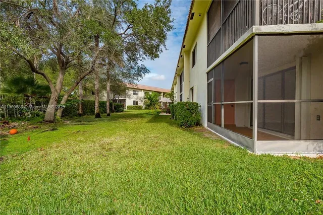 a view of a backyard with large trees