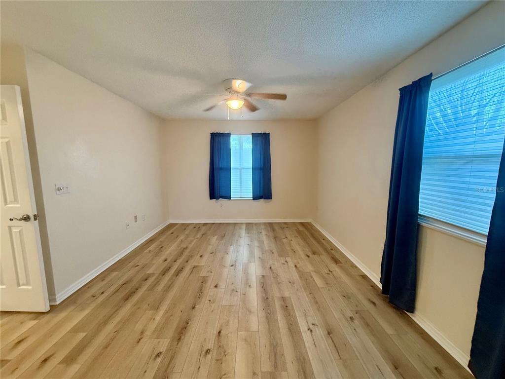 8287 Southwest 116th Street Ocala, FL 34481 - Photo 18 of 40 a view of empty room with wooden floor and fan