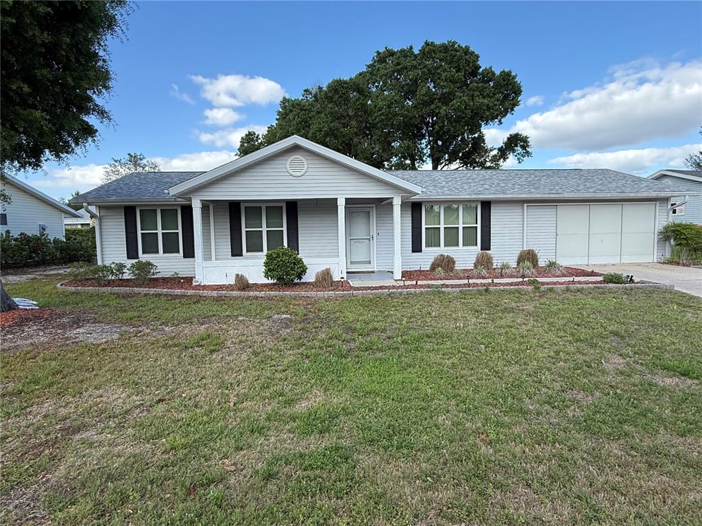 8287 Southwest 116th Street Ocala, FL 34481 - Photo 2 of 40 a front view of a house with garden
