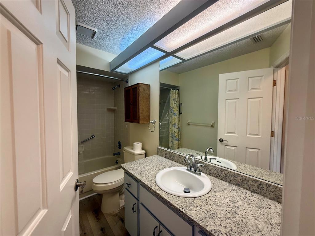 8287 Southwest 116th Street Ocala, FL 34481 - Photo 24 of 40 a bathroom with a granite countertop sink and a mirror