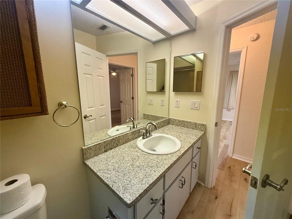8287 Southwest 116th Street Ocala, FL 34481 - Photo 27 of 40 a bathroom with a granite countertop sink and a mirror