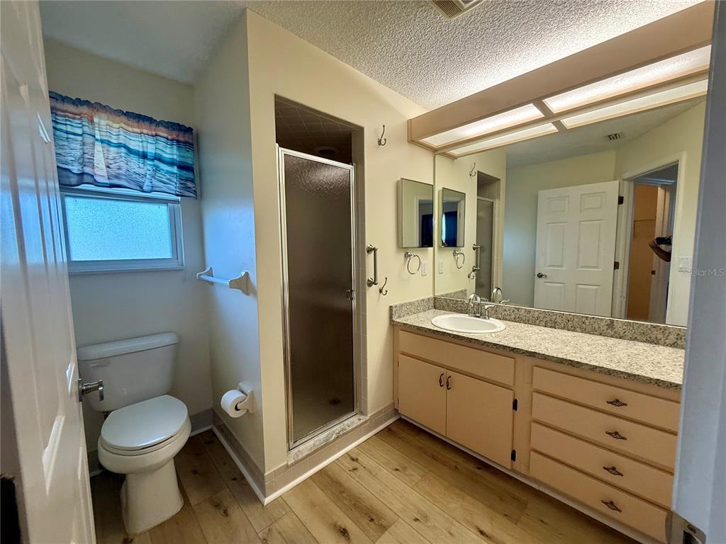 8287 Southwest 116th Street Ocala, FL 34481 - Photo 28 of 40 a bathroom with a granite countertop sink toilet and shower
