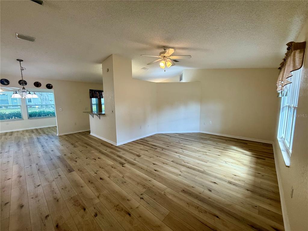 8287 Southwest 116th Street Ocala, FL 34481 - Photo 3 of 40 a view of empty room with wooden floor and fan