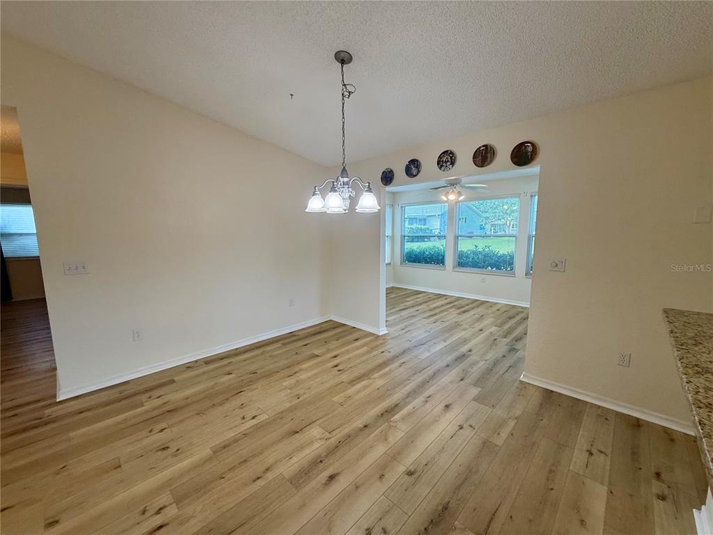 8287 Southwest 116th Street Ocala, FL 34481 - Photo 32 of 40 a view of a room with wooden floor and ceiling fan