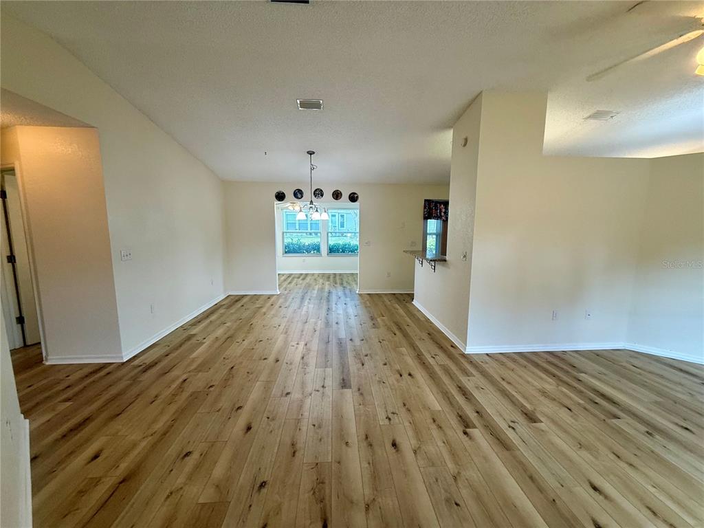8287 Southwest 116th Street Ocala, FL 34481 - Photo 4 of 40 wooden floor in an empty room with a window