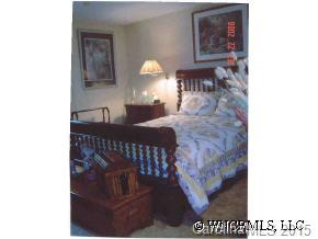 375 Riddle Cove Road Maggie Valley, NC 28751 - Photo 3 of 10 a bedroom with a bed and a lamp with window