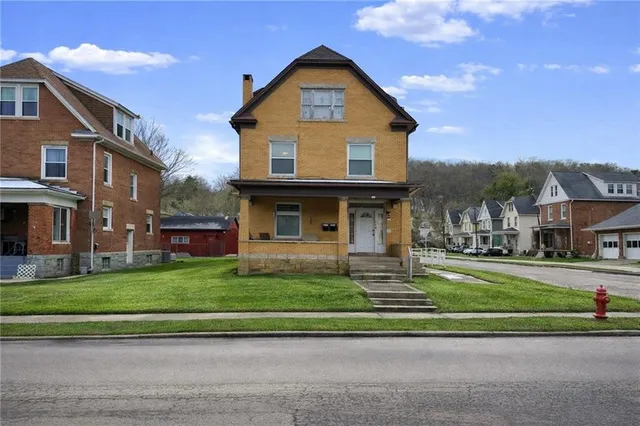 a front view of a house with a yard