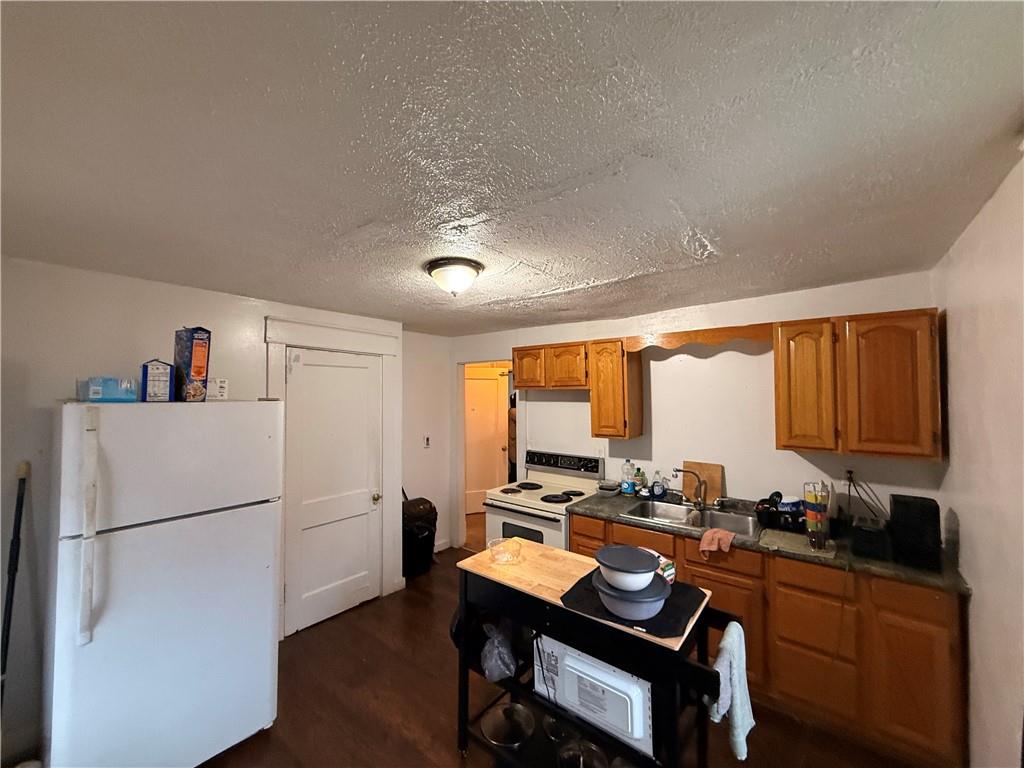 346 Mercer Street Butler, PA 16001 - Photo 14 of 19 a room with a table chairs a refrigerator and a sink