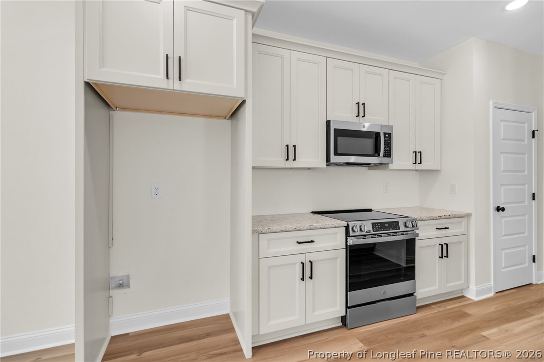 131 Merle Road Pinebluff, NC 28373 - Photo 12 of 33 a kitchen with stainless steel appliances granite countertop a stove a microwave and a refrigerator