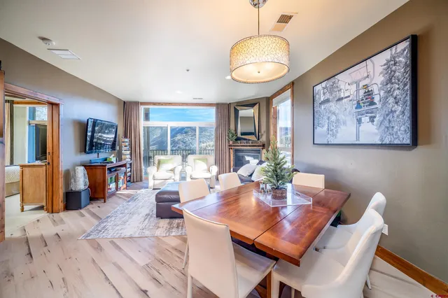 a view of a dining room with furniture window and wooden floor