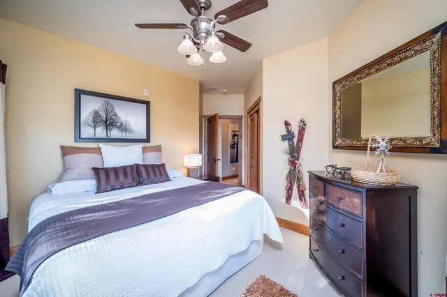 a bedroom with a large bed and a chandelier