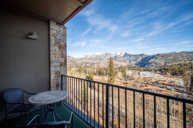 a view of a balcony with furniture