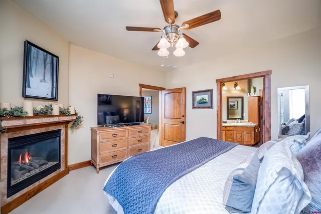 a bedroom with a bed and a television with dresser