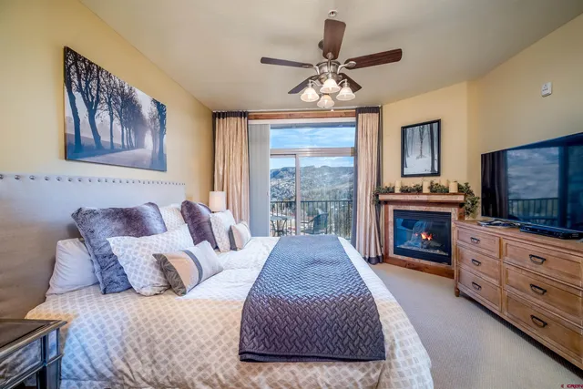 a spacious bedroom with a bed and flat screen tv