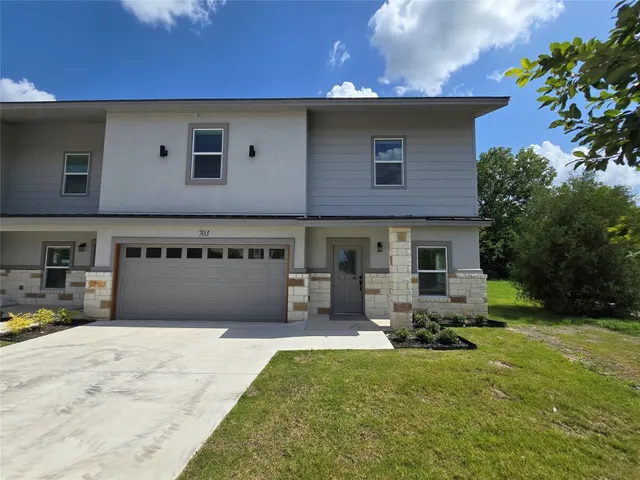 a front view of a house with a yard