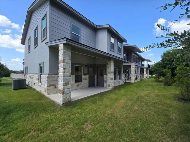a view of a house with a yard porch and sitting area