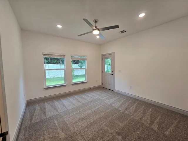 an empty room with windows and closet